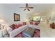 Bright living room with comfy sofas, decorative pillows, and a view into the dining area at 1105 Gondola Park Dr # 1105, Venice, FL 34292