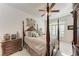 Spacious main bedroom with a four-poster bed and plenty of natural light at 1105 Gondola Park Dr # 1105, Venice, FL 34292