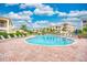 Community pool with lounge chairs and building view at 1105 Gondola Park Dr # 1105, Venice, FL 34292