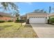 Tan one-story house with white garage door and landscaping at 11508 Water Willow Ave, Lakewood Ranch, FL 34202