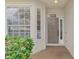 Front door entry with gray door and brick pavers at 11508 Water Willow Ave, Lakewood Ranch, FL 34202