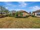 Landscaped backyard with a well-maintained lawn and tropical plants at 12785 Fontana Loop, Bradenton, FL 34211