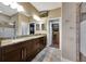 Double vanity bathroom with granite countertops and large walk-in closet at 12785 Fontana Loop, Bradenton, FL 34211