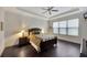 Spacious bedroom with hardwood floors, ceiling fan, and large window at 12785 Fontana Loop, Bradenton, FL 34211