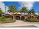 Elegant community clubhouse with palm trees and inviting entryway at 12785 Fontana Loop, Bradenton, FL 34211