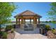 Lakeside gazebo with seating and brick pathway at 12785 Fontana Loop, Bradenton, FL 34211