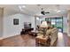 Bright living room with hardwood floors, comfortable seating, and access to a patio at 12785 Fontana Loop, Bradenton, FL 34211