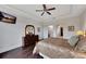 Main bedroom with hardwood floors, dresser, and access to en-suite bathroom at 12785 Fontana Loop, Bradenton, FL 34211