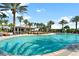Large, resort-style pool with plenty of lounge chairs and palm trees at 12785 Fontana Loop, Bradenton, FL 34211