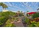 Landscaped backyard with path, garden, and patio furniture at 131 Pinehurst Dr # 131, Bradenton, FL 34210