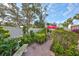 Relaxing courtyard with brick path, greenery, and seating area at 131 Pinehurst Dr # 131, Bradenton, FL 34210