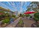 Landscaped backyard with brick path and patio seating at 131 Pinehurst Dr # 131, Bradenton, FL 34210