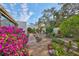 Landscaped backyard oasis with lush plantings and patio seating at 131 Pinehurst Dr # 131, Bradenton, FL 34210