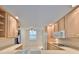 View of kitchen with light wood cabinets and white appliances at 131 Pinehurst Dr # 131, Bradenton, FL 34210