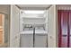 Laundry closet with washer, dryer, and shelving at 131 Pinehurst Dr # 131, Bradenton, FL 34210