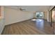 Spacious living room with wood-look floors and sliding doors at 131 Pinehurst Dr # 131, Bradenton, FL 34210