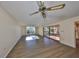 Bright living room with wood-look floors and sliding glass doors at 131 Pinehurst Dr # 131, Bradenton, FL 34210