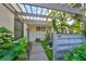 Inviting patio with pergola, lush landscaping, and a bird bath at 131 Pinehurst Dr # 131, Bradenton, FL 34210