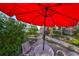 Cozy patio with red umbrella and garden views at 131 Pinehurst Dr # 131, Bradenton, FL 34210