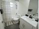 Bathroom with tub, toilet and single vanity at 1317 E Osborne Ave, Tampa, FL 33603
