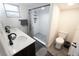 Bathroom with double vanity, shower, and dark wood cabinets at 1317 E Osborne Ave, Tampa, FL 33603