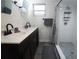 Bathroom with double vanity, shower, and dark wood cabinets at 1317 E Osborne Ave, Tampa, FL 33603