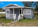 Gray house with white trim, front porch, and small yard at 1317 E Osborne Ave, Tampa, FL 33603