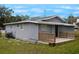 Gray house with wooden deck and fenced backyard at 1317 E Osborne Ave, Tampa, FL 33603