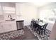 Kitchen with white cabinets, stainless steel appliances, and a dining area at 1317 E Osborne Ave, Tampa, FL 33603
