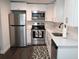 Small kitchen with stainless steel appliances and white cabinets at 1317 E Osborne Ave, Tampa, FL 33603
