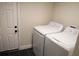 Laundry room with washer, dryer, and exterior access at 1317 E Osborne Ave, Tampa, FL 33603