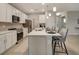 Kitchen island with seating, quartz countertops, and stainless steel appliances at 1342 Shaker Ln, North Port, FL 34286