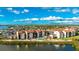 Aerial view of waterfront condo community with pool and lush landscaping at 1608 Stickney Point Rd # 1608-102, Sarasota, FL 34231