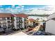 Aerial view of condo building with parking and waterfront access at 1608 Stickney Point Rd # 1608-102, Sarasota, FL 34231