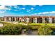 Aerial view of waterfront community with pool, tennis court, and lush landscaping at 1608 Stickney Point Rd # 1608-102, Sarasota, FL 34231