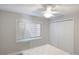 Bedroom with double doors, window blinds, and ceiling fan at 1608 Stickney Point Rd # 1608-102, Sarasota, FL 34231