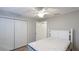 Bedroom featuring a queen bed, white closet doors and ceiling fan at 1608 Stickney Point Rd # 1608-102, Sarasota, FL 34231