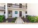 Condo building exterior featuring walkway and landscaping at 1608 Stickney Point Rd # 1608-102, Sarasota, FL 34231