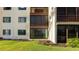Building exterior showcasing sliding glass doors and lawn at 1608 Stickney Point Rd # 1608-102, Sarasota, FL 34231