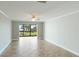 Spacious living room with tile flooring and access to a patio overlooking the water at 1608 Stickney Point Rd # 1608-102, Sarasota, FL 34231