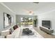 Living room features a comfy sofa, water view, and stylish decor at 1608 Stickney Point Rd # 1608-102, Sarasota, FL 34231