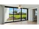 Stunning view of the water and palm trees from sliding glass doors at 1608 Stickney Point Rd # 1608-102, Sarasota, FL 34231