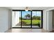 Waterfront view from sliding glass doors, showcasing lush landscaping and palm trees at 1608 Stickney Point Rd # 1608-102, Sarasota, FL 34231