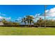 Landscaped waterfront lawn with palm trees and seating at 1608 Stickney Point Rd # 1608-102, Sarasota, FL 34231