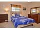 Bedroom with double windows, wood dresser and blue bedding at 1864 Mid Ocean Cir, Sarasota, FL 34239