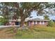 Brick ranch home with mature tree and landscaped lawn at 1864 Mid Ocean Cir, Sarasota, FL 34239
