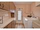 Bright laundry room, washer, dryer, and built-in cabinets at 1864 Mid Ocean Cir, Sarasota, FL 34239