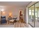 Living room features wood-look tile floors and access to other rooms at 1864 Mid Ocean Cir, Sarasota, FL 34239