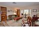 Living room features hardwood floors, bay window and built-in shelving at 1864 Mid Ocean Cir, Sarasota, FL 34239