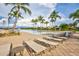 Spacious pool deck with lounge chairs and lake access at 215 Toscavilla Blvd, Nokomis, FL 34275